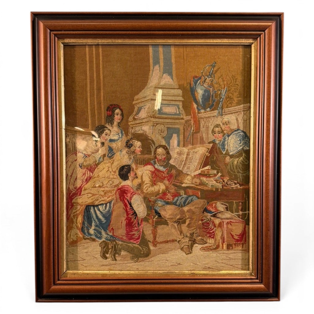 European Needlepoint Interior Scene: Framed European needlepoint panel depicting a courtly or scholarly interior scene with seated gentleman, attendants, and architectural furnishings, mounted under glass in a wood and gilt frame.