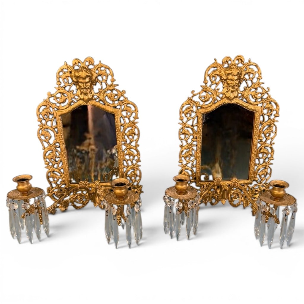 Pair of French Gilt Girandole Mirrored Wall Sconces: Pair of French gilt metal girandole mirrored wall sconces, each with an ornate pierced scrolling acanthus frame centered by a shaped mirror plate and surmounted by a mask-form crest. Each sconce