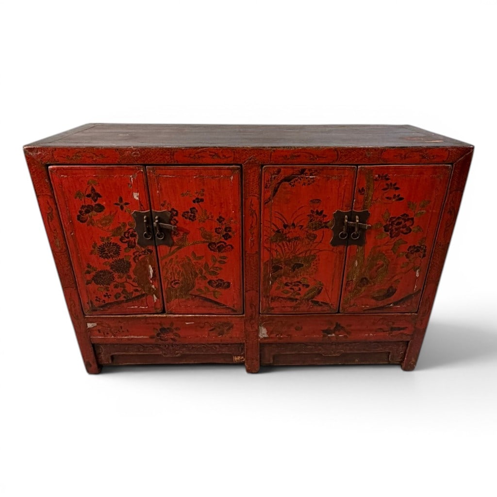 Chinese Red Lacquer Sideboard Cabinet, Late Qing Dynasty: A Chinese red lacquer sideboard cabinet, late Qing Dynasty, of rectangular form with four paneled cabinet doors opening to divided interior storage with shelves. The front is decorated in aged red