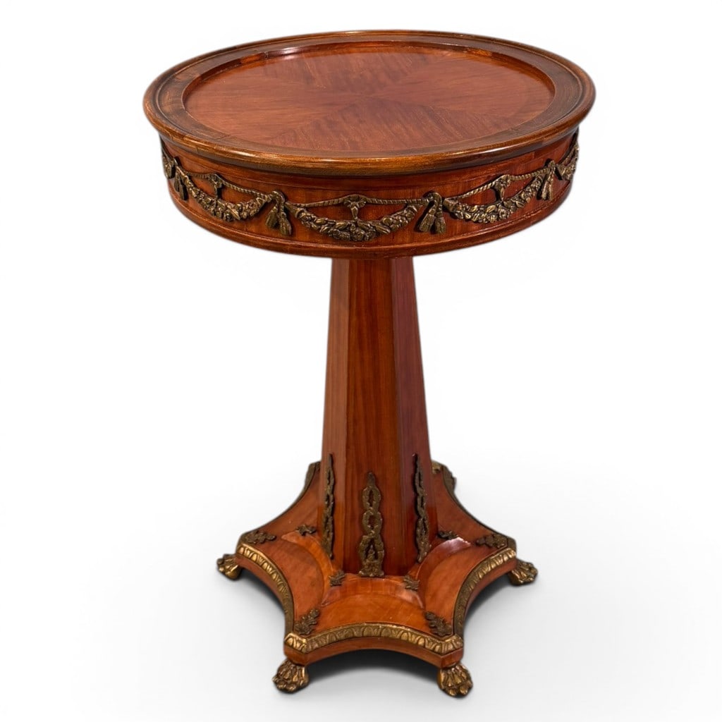 French Louis XVI-Style Gilt-Metal Mounted Gueridon or Plant Stand: French Louis XVI-style circular gueridon or plant stand, the round top with inset radial veneer within a raised molded gallery, above a deep frieze mounted with gilt-metal floral swags, ribbons, and