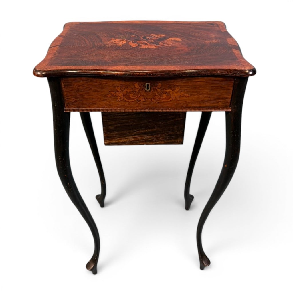 Victorian Inlaid Rosewood Sewing Table: Victorian inlaid rosewood sewing table or work table, 19th century, having a shaped hinged top with contrasting satinwood banding and central floral marquetry inlay. The lid opens to a fitted divided