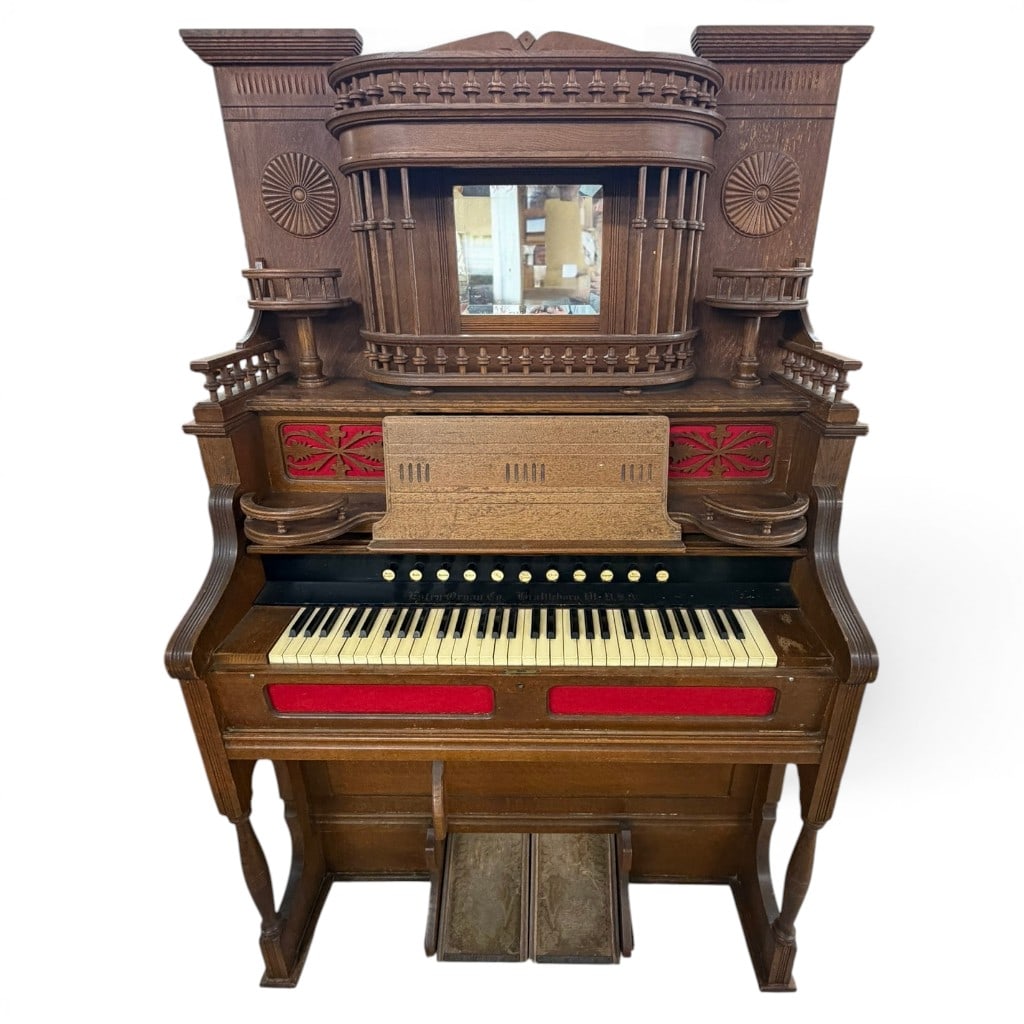 Estey Organ Co. Victorian Oak Pump Organ: Estey Organ Co., Brattleboro, Vermont, Victorian oak pump organ, the case with an architectural upper gallery having turned spindle rail, central mirror, flanking circular sunburst carvings, small sid