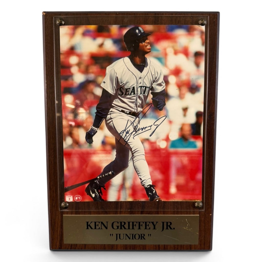 Signed Ken Griffey Jr. Seattle Mariners Photograph Plaque: Signed color photograph of Ken Griffey Jr. in Seattle Mariners uniform, mounted in a wood-grain presentation plaque with brass-tone nameplate reading ?Ken Griffey Jr. ?Junior.?? The photograph bears