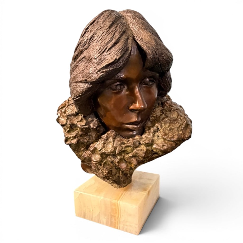 Bronze-Finished Female Bust on Onyx Base, Contemporary: Bronze-finished figural bust of a young woman, 20th/21st century, modeled with stylized hair and textured floral or foliate collar, raised on a square polished onyx base. Decorative sculptural work