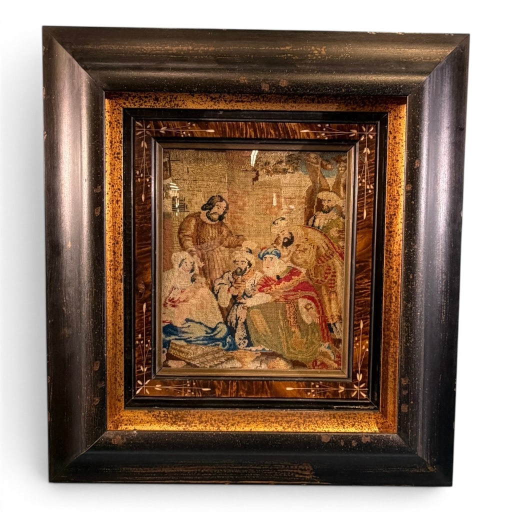 Framed Needlepoint Figural Scene: Framed needlepoint panel depicting a historic interior figural scene with multiple figures, mounted under glass in a deep shadow box style frame with faux tortoise/inlaid-style decoration and dark out