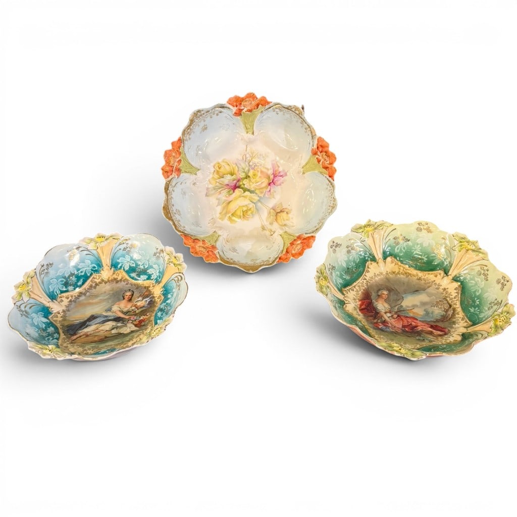 Group of Three R.S. Prussia Porcelain Bowls: Group of three R.S. Prussia porcelain bowls, each with molded scalloped floral-form rim, raised floral decoration, gilt highlights, and hand-painted decoration. Includes two portrait/figural scenic