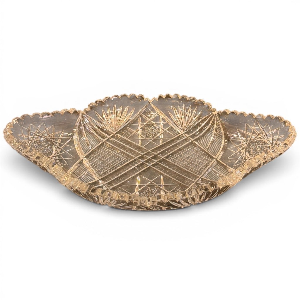 American Brilliant Period Cut Glass Tray: American Brilliant Period cut glass tray or celery dish, of elongated shaped form with scalloped and notched rim, deeply cut with hobstar, fan, crosshatch, and geometric motifs throughout. Dimensions: