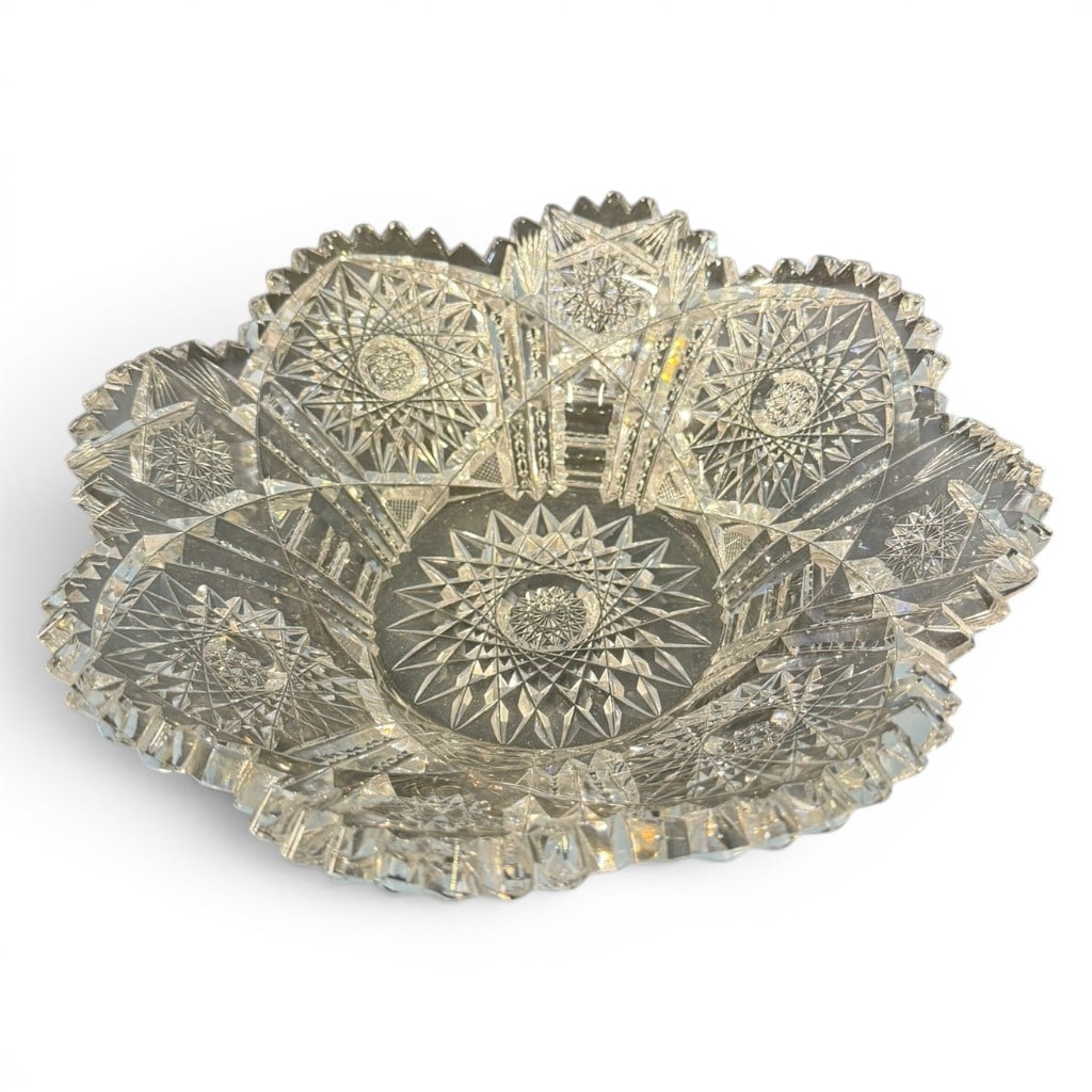American Brilliant Period Cut Glass Bowl: American Brilliant Period cut glass bowl, circular form with scalloped rim, deeply cut with repeating hobstar medallions, fan panels, crosshatch fields, and geometric motifs. 9.5 in. diameter.