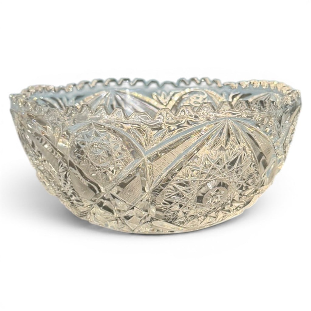 American Brilliant Period Cut Glass Bowl: American Brilliant Period cut glass bowl, circular form with scalloped rim, deeply cut with large hobstar medallions, fan and star devices, crosshatch grounds, and geometric panels. 8.5 in. diameter.
