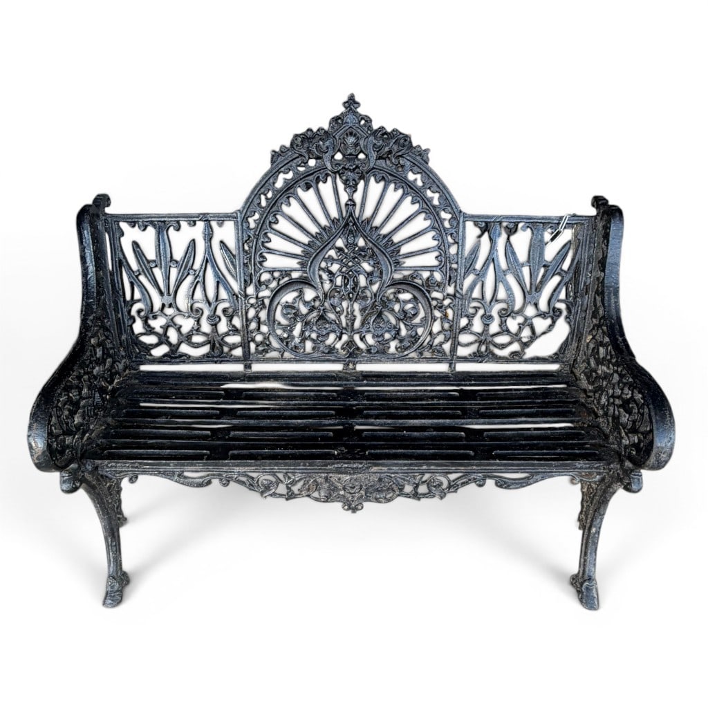 Victorian Cast Iron Garden Bench: Black painted cast iron garden bench with ornate pierced back, arms, and apron, the back centered by a tall Gothic Revival-style fan and foliate medallion panel, flanked by geometric and scrolling