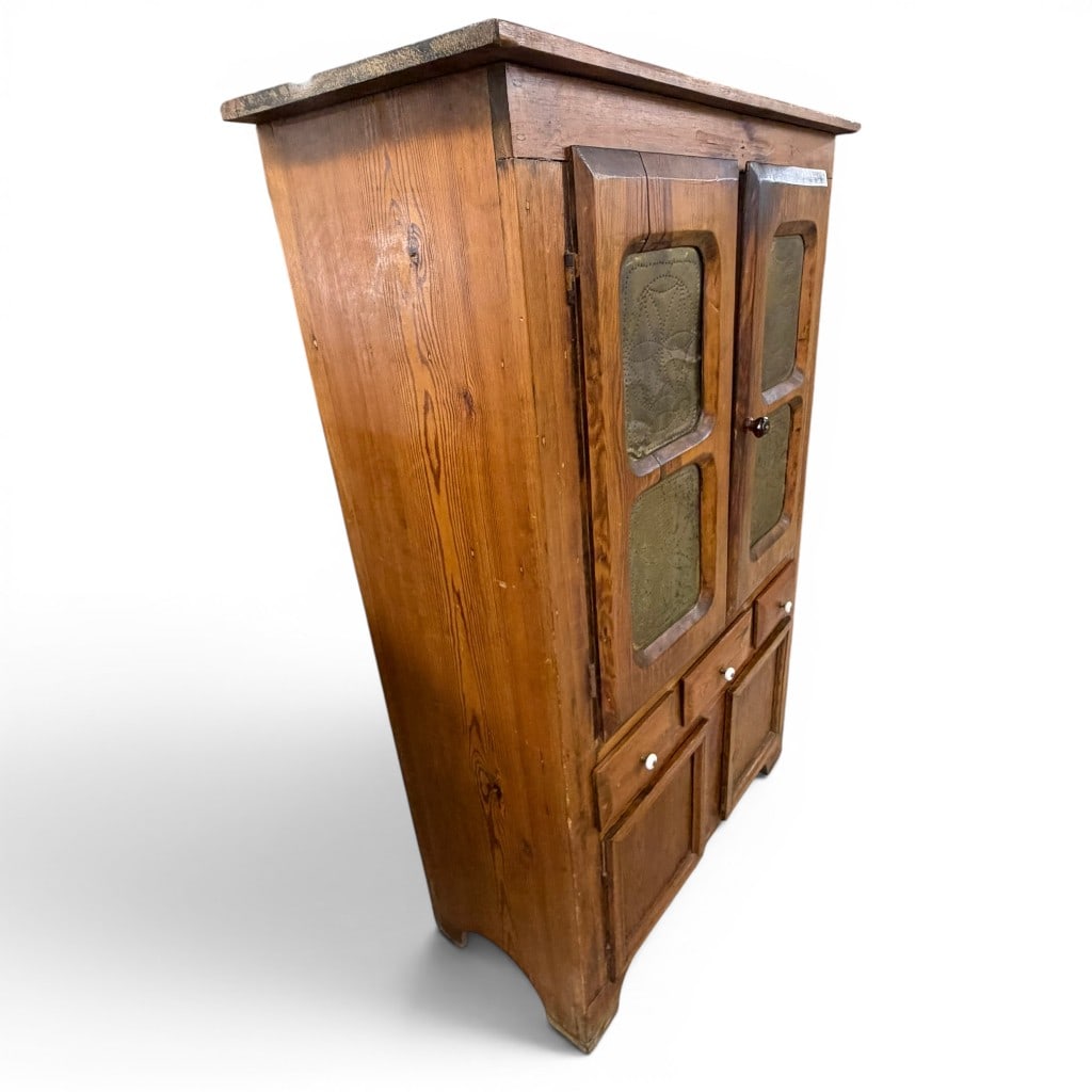 American Pine Pie Safe With Punched Tin Panels, 19th Century: American pine pie safe, 19th century, having an overhanging top above two tall cupboard doors fitted with four gold painted or brass toned punched tin panels decorated with star and floral motifs, abo