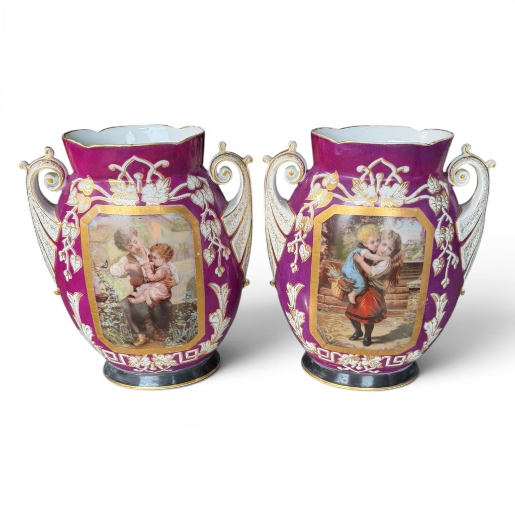 Pair of Old Paris Porcelain Portrait Vases: Pair of Old Paris style porcelain vases, late 19th to early 20th century, each with magenta ground, gilt and white foliate decoration, scrolling handles, black foot, and central transfer or painted