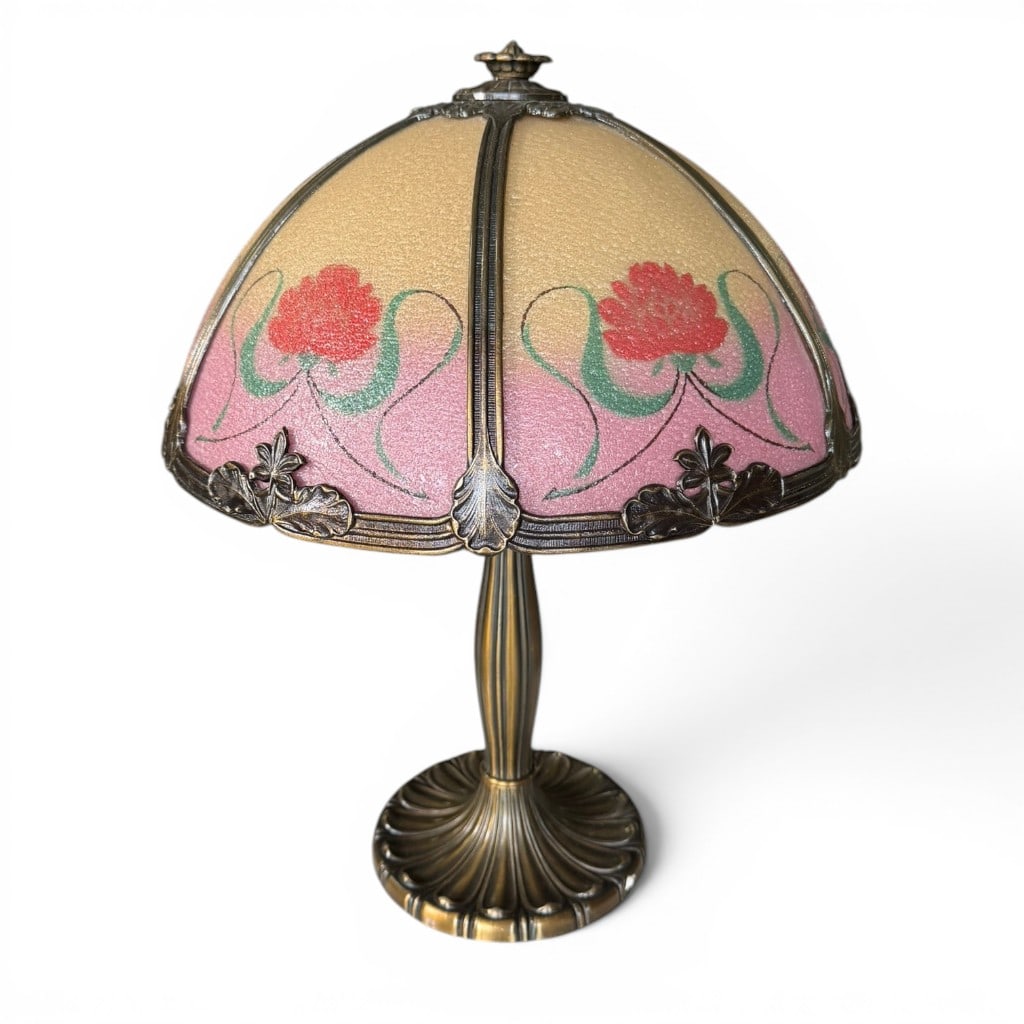 Art Nouveau Style Floral Slag Glass Table Lamp: Art Nouveau style floral slag glass table lamp, 20th century, having a domed panel shade in soft pink and cream slag glass with red floral decoration and green tendril accents, set in a patinated