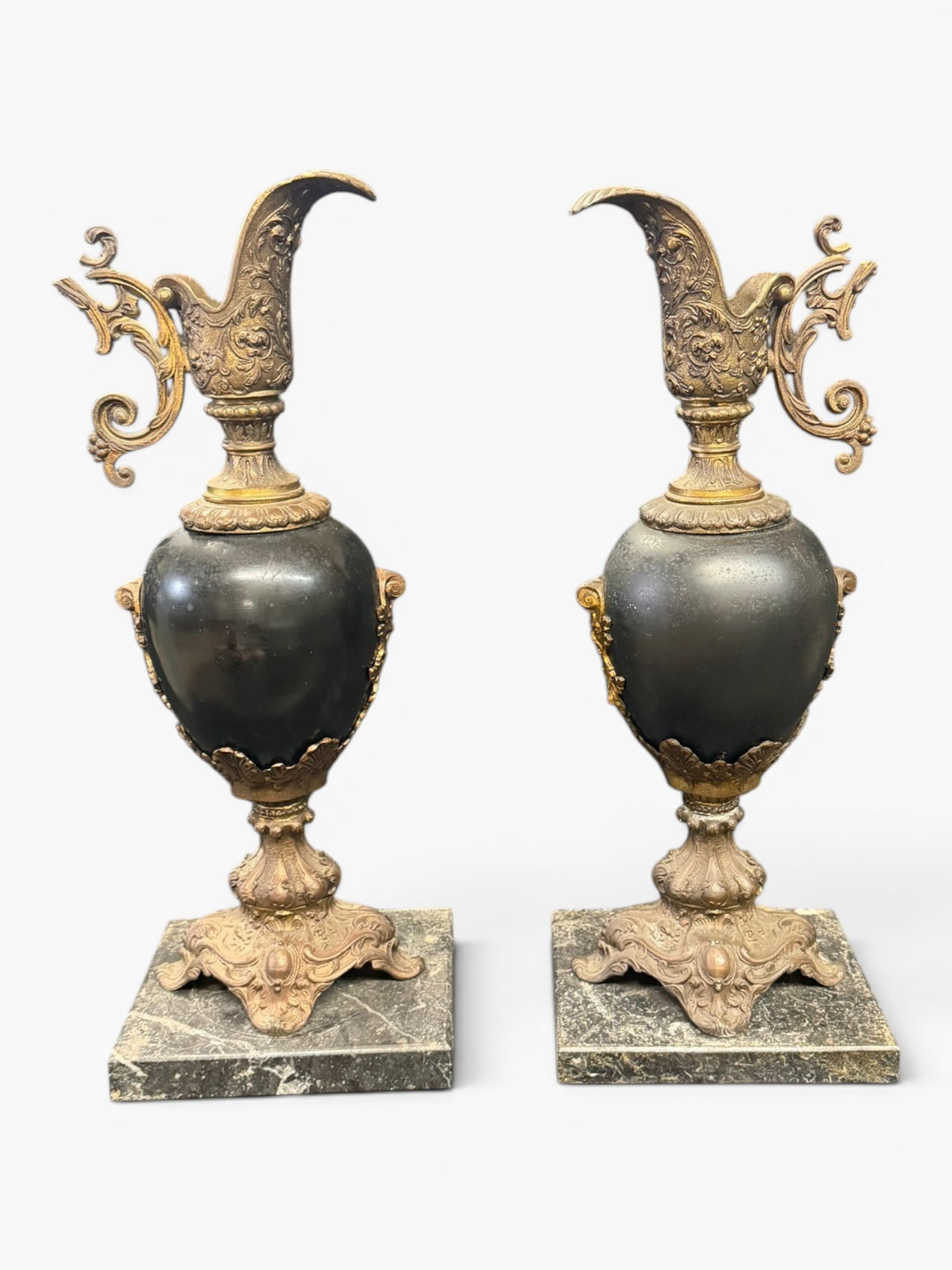 Pair French Gilt-Brass Mounted Dark Stone Ewers: Date: Late 19th to early 20th century, circa 1890?1910Period/Style: French Belle ?poque, Louis XV RevivalMaterials: Gilt brass, dark stone, and veined marbleForm: Pair of decorative ewersDescription: