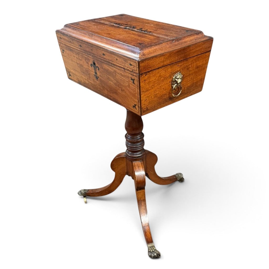 English Regency Mahogany Tea Poy: Origin: EnglandDate: Circa 1820-1830Period/Style: RegencyMaterials: Mahogany and mahogany veneer, contrasting darkwood inlay, brass hardware, and fabric-lined interiorsForm: Pedestal tea