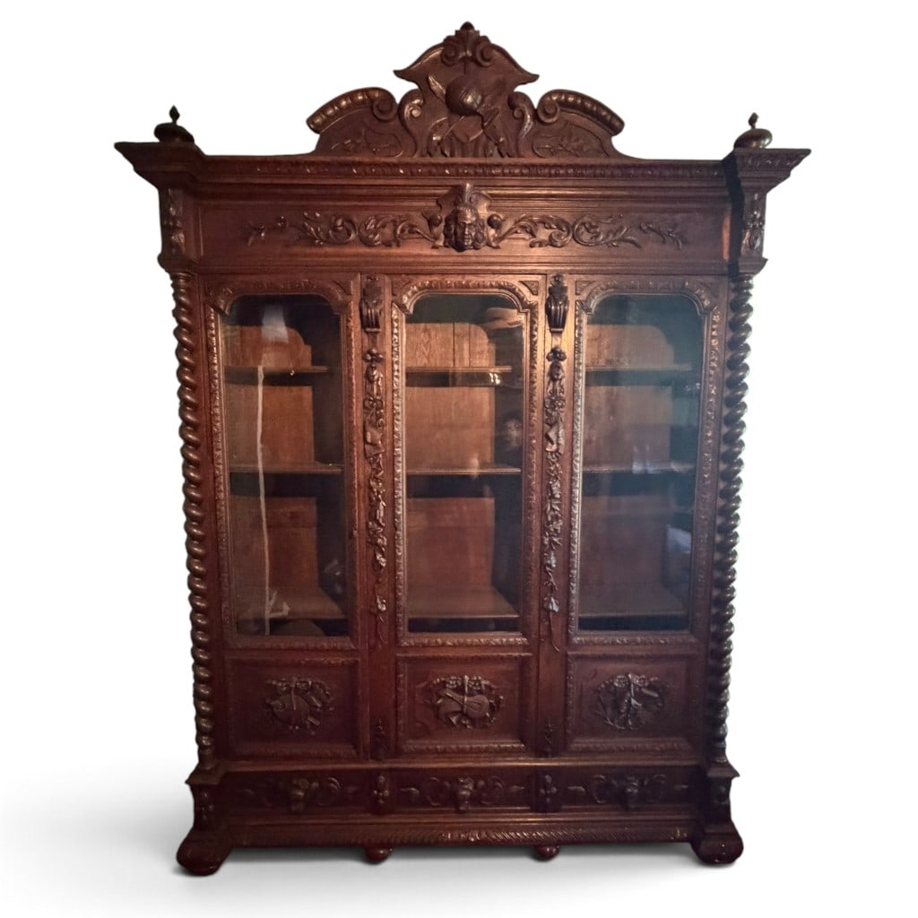 French Renaissance Revival Walnut Bookcase: Origin: FranceDate: Circa 1880-1900Period/Style: Renaissance Revival, Henri II RevivalMaterials: Carved walnut, glass, unidentified secondary woods, and metal hardwareForm: Bibliotheque or library boo