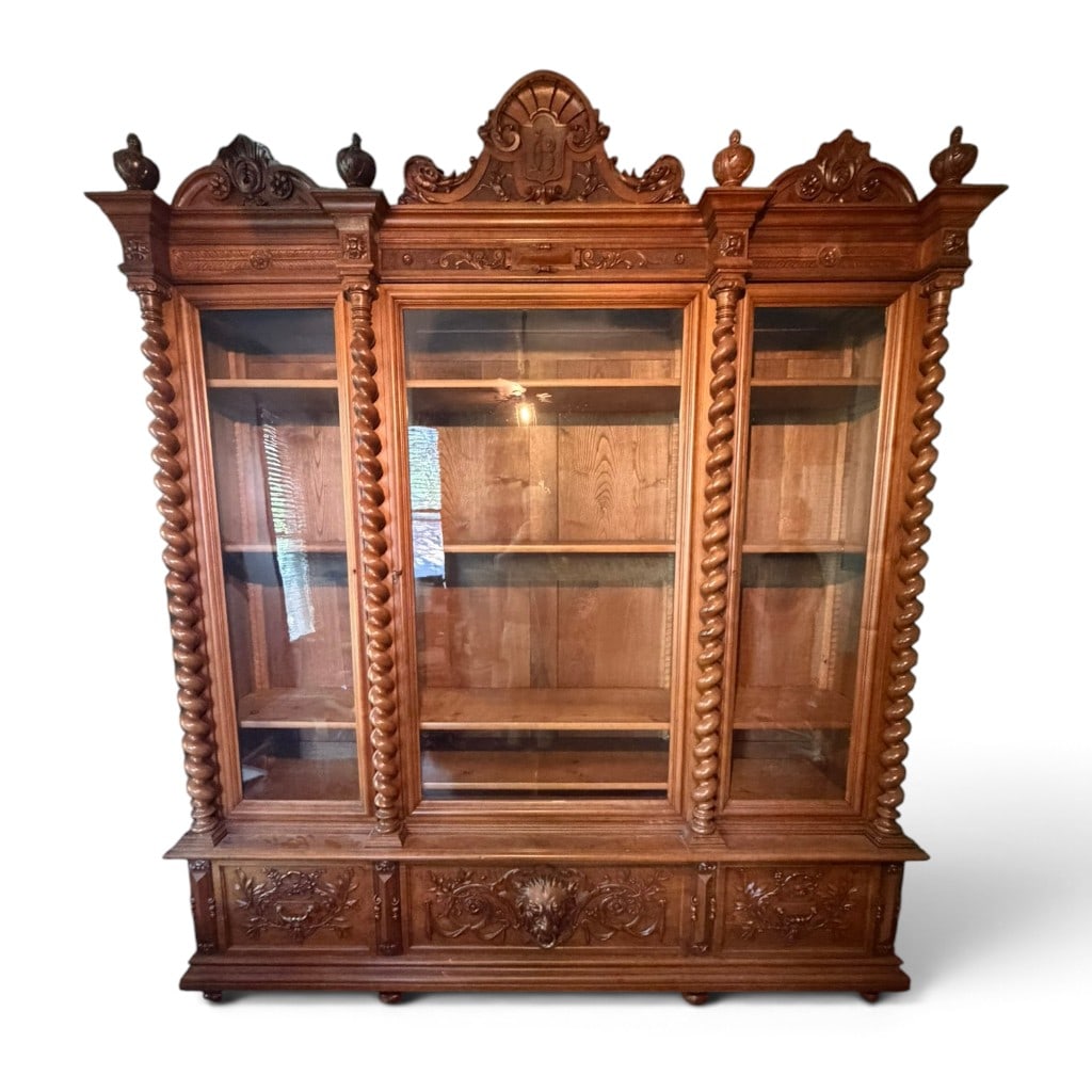 French Carved Oak Hunt Bookcase: Origin: Probably FranceDate: Circa 1880-1900Period/Style: Renaissance Revival, Henri II Revival, Hunt styleMaterials: Carved oak, glass, unidentified secondary woods, and metal hardwareForm: Monumenta