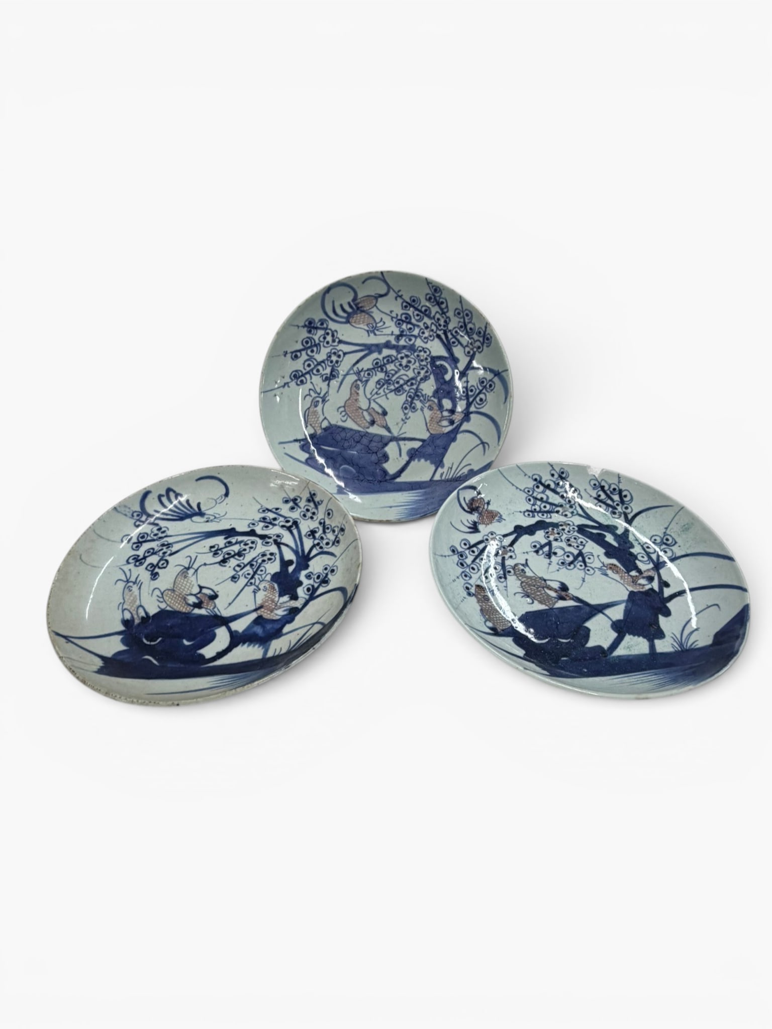 Three Chinese Qing Blue and Red Bird Plates: Origin: China, probably JingdezhenDate: 18th century, probably early 18th centuryPeriod/Style: Qing dynasty, probably Kangxi periodMaterials: Porcelain with underglaze cobalt blue and iron-red