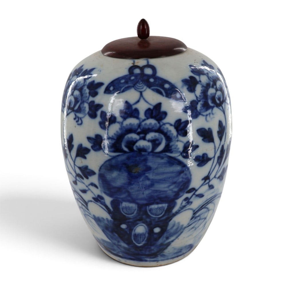 Chinese Blue-and-White Porcelain Jar: Maker: Unidentified Chinese manufactureOrigin: ChinaDate: Late Qing dynasty, circa 1880-1900Period/Style: Chinese Qing dynastyMaterials: Underglaze-blue decorated porcelain and carved hardwoodForm: Co