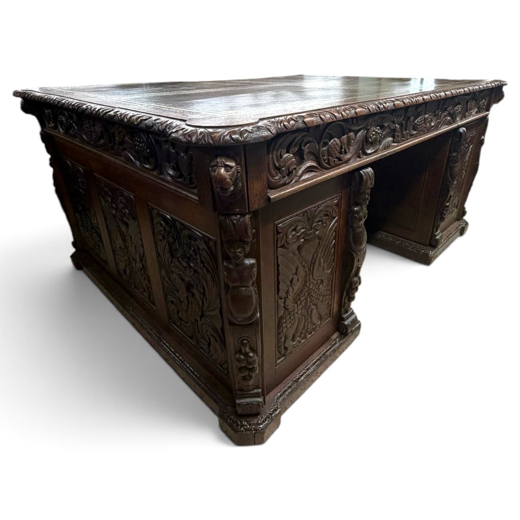 Continental Renaissance Revival Carved Oak Pedestal Desk, Circa 1900: Origin: Continental Europe Date: Circa 1900-1920 Period/Style: Renaissance Revival, Neo-Renaissance Materials: Carved oak, mixed secondary woods, leather, metal hardware, and paper labels Form: Enclos