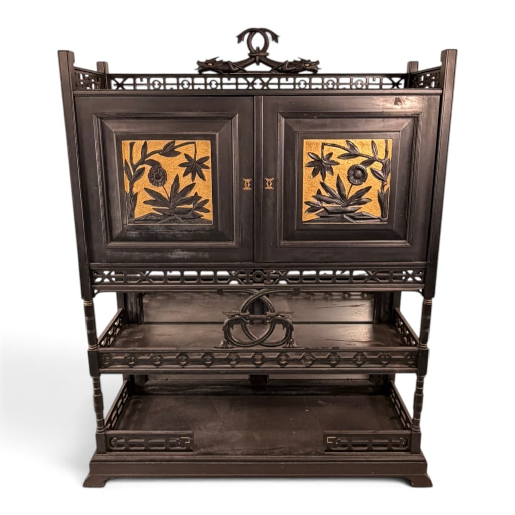 Anglo-Japanese Aesthetic Dragon Cabinet: Origin: Probably England. Date: Circa 1880-1890. Period/Style: Anglo-Japanese Aesthetic Movement. Materials: Ebonized wood, carved relief decoration, gilt-painted accents, mirror glass, brass