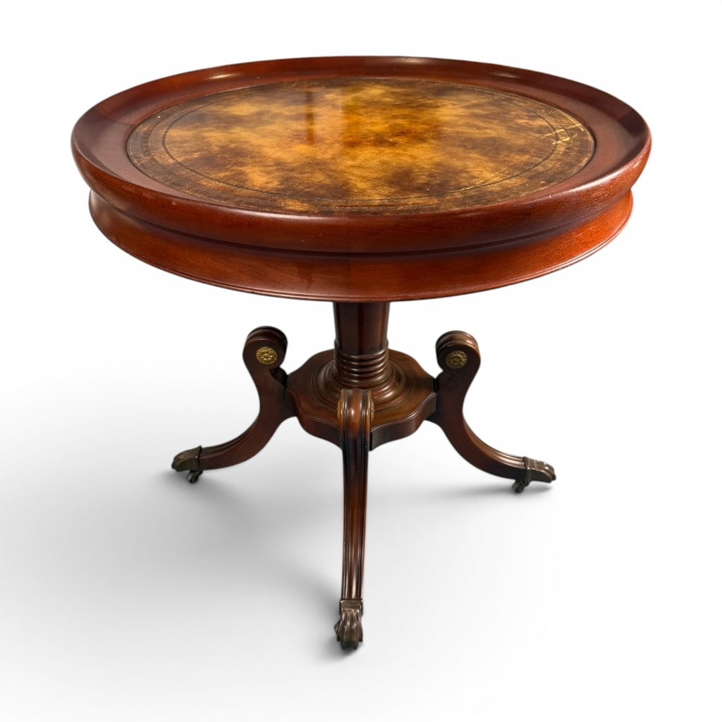 Empire Revival Mahogany Leather-Top Table: Origin: American Date: Circa 1900-1920 Period/Style: American Empire Revival Materials: Mahogany, mahogany veneer, leather, and brass Form: Circular center or occasional table Description: American