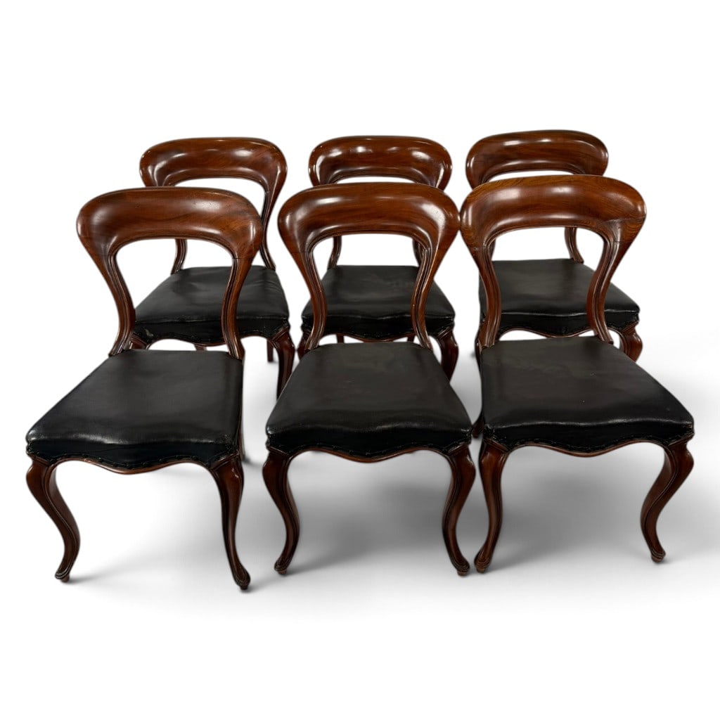Six Victorian Mahogany Dining Chairs: Origin: England. Date: Circa 1845-1860. Period/Style: Mid-Victorian. Materials: Mahogany and black leather upholstery. Description: Set of six English mid-Victorian mahogany dining chairs, circa