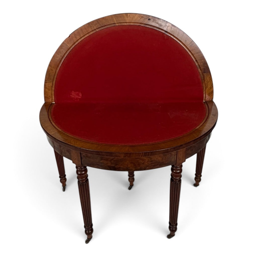 French Louis-Philippe Figured Mahogany Demilune Games Table: Origin: France Date: Circa 1840-1860 Period/Style: Louis-Philippe Materials: Figured mahogany, mahogany veneer, oak secondary wood, red baize, and metal Form: Demilune games or card table Descripti