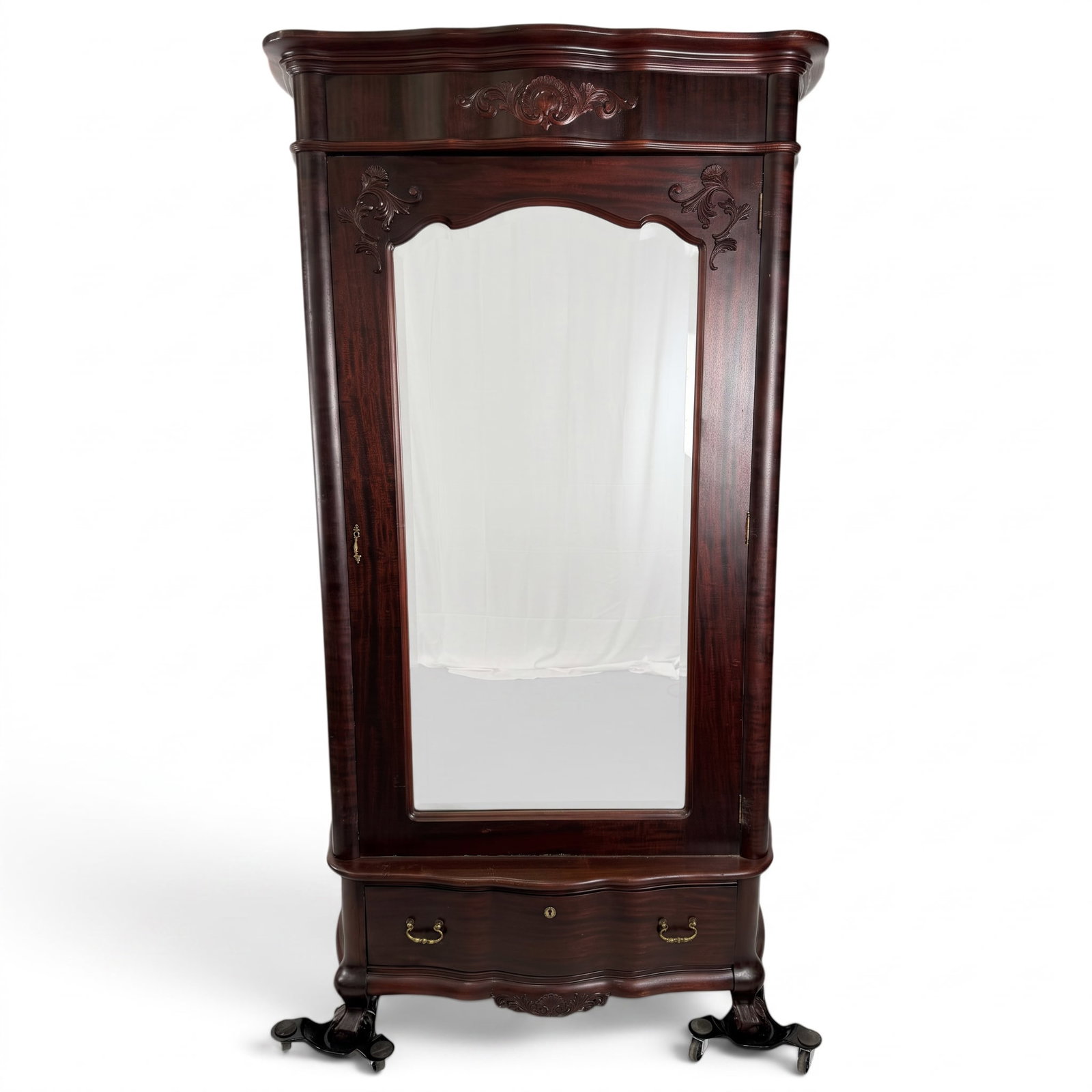 American Rococo Revival Mahogany Mirrored Wardrobe: Origin: American Date: Circa 1865-1880 Period/Style: Victorian, Rococo Revival Materials: Figured mahogany, mahogany veneer, birdseye maple, mirror glass, brass, and iron Form: Single-door mirrored