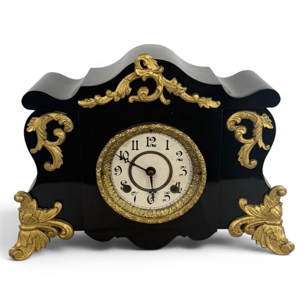 Black Enameled Gilt Metal Mantel Clock: Origin: American Date: Circa 1890-1910 Period/Style: Late Victorian, Rococo Revival Materials: Black enameled metal, gilt metal, glass, brass, and steel Description: American late-Victorian mantel