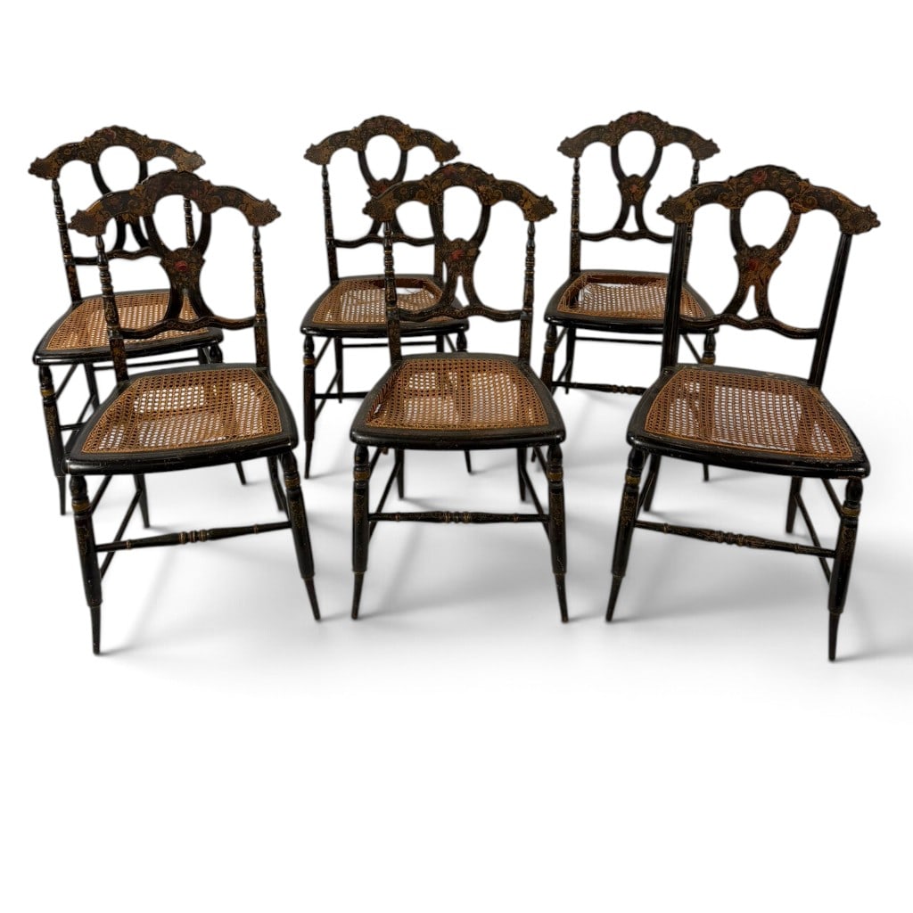 Six Ebonized Floral Cane Seat Chairs: Origin: Probably English Date: Circa 1880-1900 Period/Style: Late Victorian, Aesthetic Movement Materials: Ebonized wood, polychrome and gilt decoration, and cane Description: Set of six
