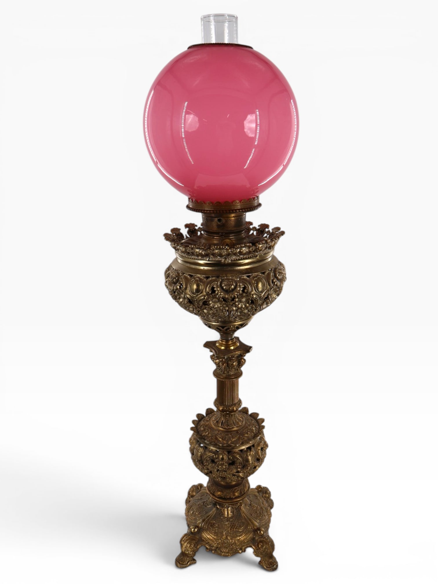 Victorian Brass Lamp with Pink Shade: Maker: Unidentified; Burner fitting marked Made in U.S. of America Origin: United States Date: Late 19th to early 20th century Period/Style: Victorian / Renaissance Revival Materials: Brass, cast meta