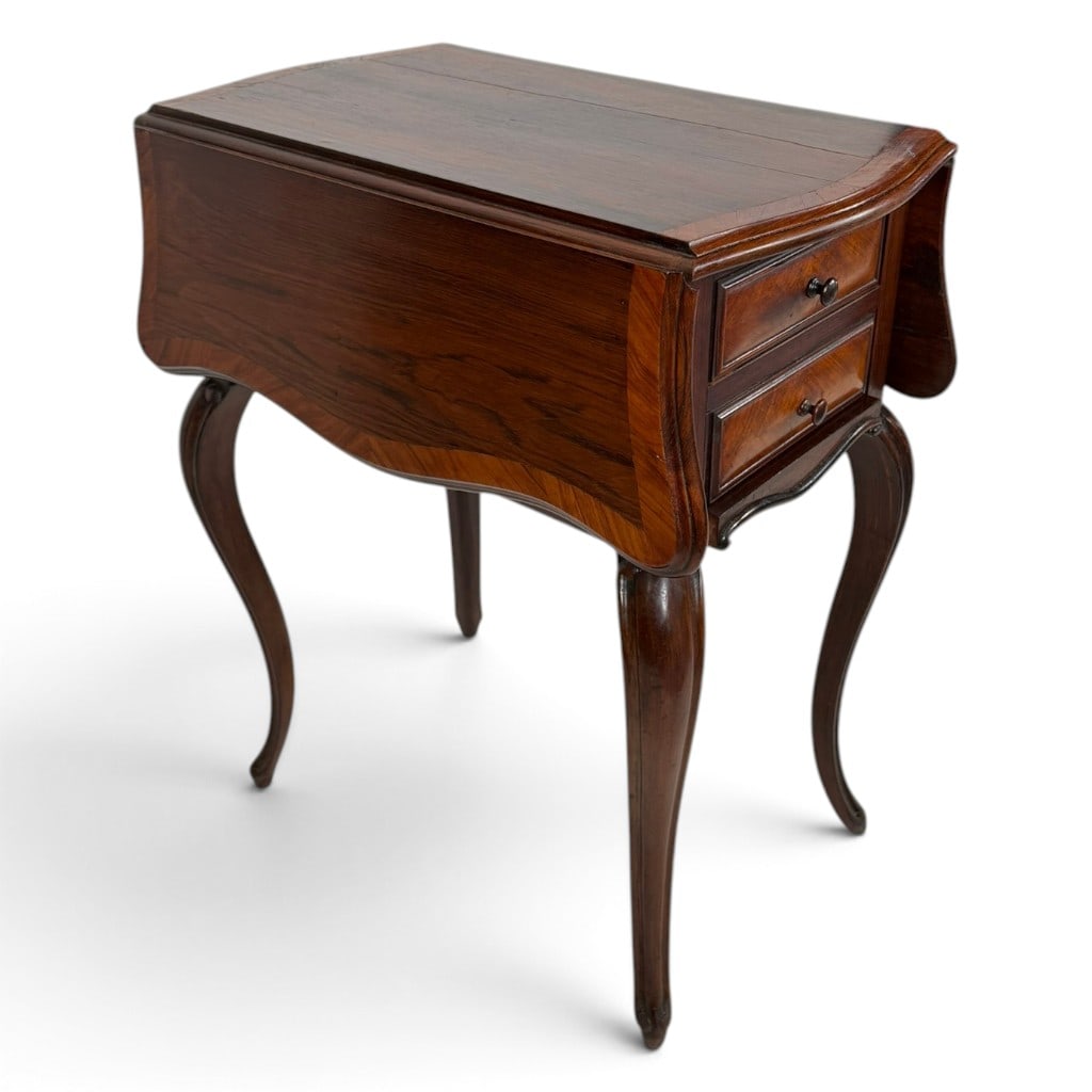 French Napoleon III Rosewood Drop-Leaf Table: Origin: French Date: Circa 1860-1880 Period/Style: Napoleon III Materials: Rosewood, rosewood veneer, mixed secondary woods, and metal hardware Description: A distinctive French Napoleon III work