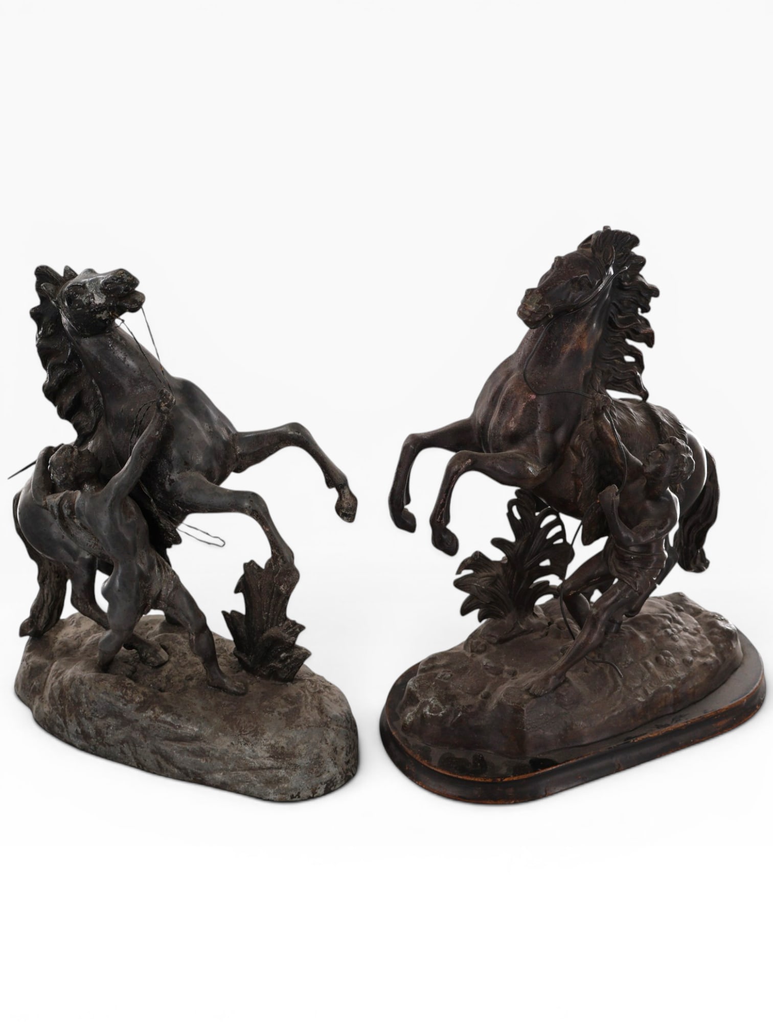 Near Pair Marly Horse Figural Groups: Artist: After Guillaume Coustou the Elder (French, 1677-1746) Origin: Continental Europe Date: Late 19th to early 20th century Period/Style: Neoclassical Revival Materials: Patinated cast metal and