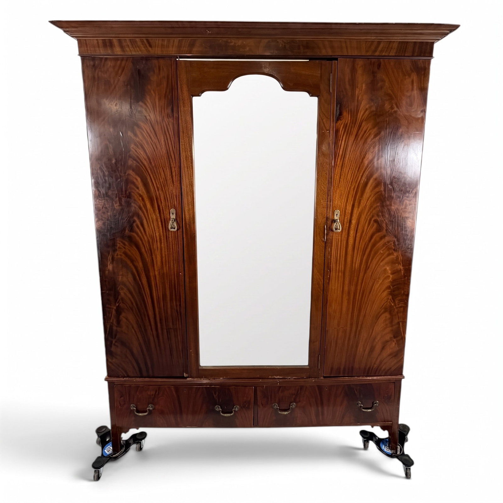 William IV Flame Mahogany Wardrobe: Origin: Probably England Date: Circa 1830-1845 Period/Style: William IV, early Victorian Materials: Mahogany, flame mahogany veneer, oak and mixed secondary woods, mirror glass, brass and metal