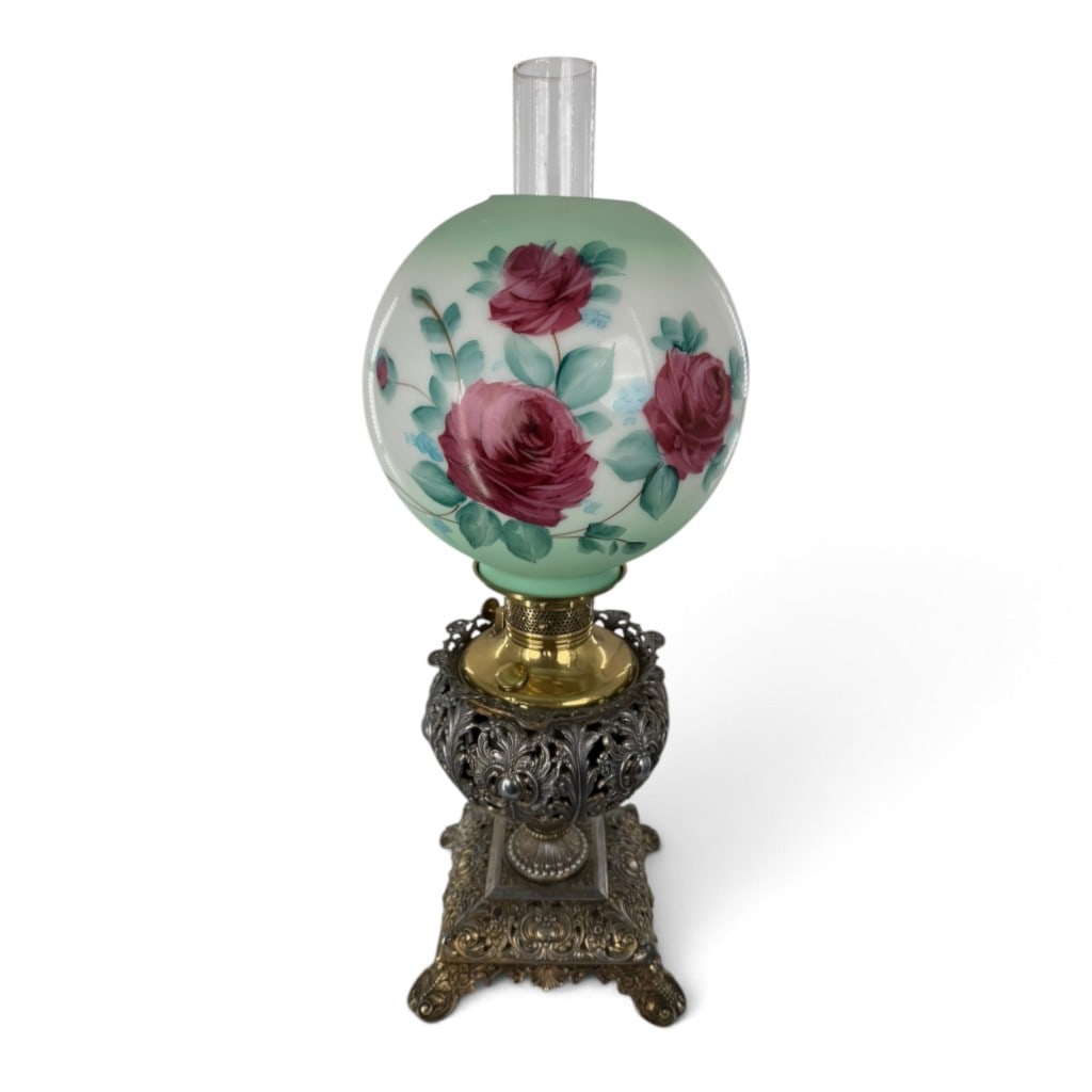 Victorian Floral Glass Banquet Oil Lamp: Origin: American Date: Circa 1890-1910 Period/Style: Late Victorian Materials: Hand-painted opal glass, clear glass, cast metal, brass, and metal oil-lamp components Form: Banquet or parlor oil lamp <