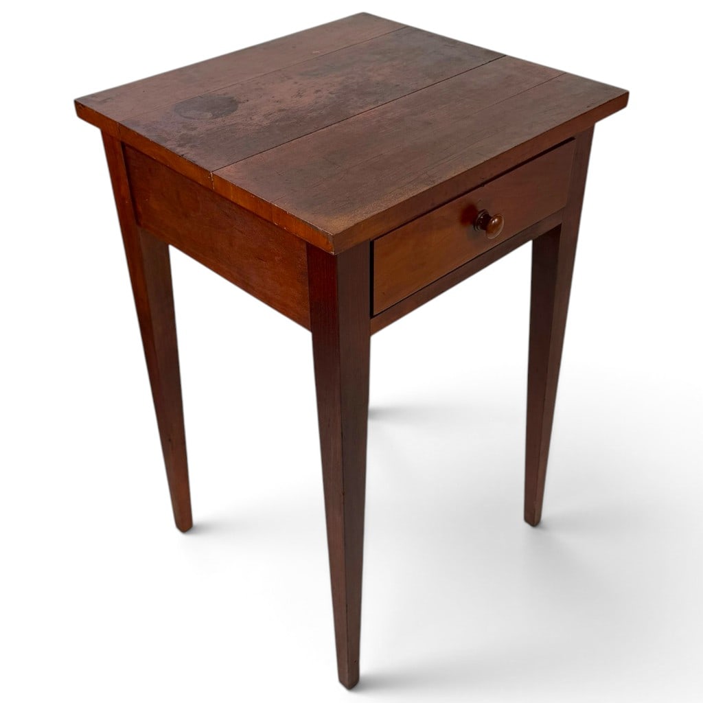 American Country Federal Cherry One-Drawer Stand: Origin: American Date: Circa 1820-1840 Period/Style: Country Federal, Hepplewhite influenced Materials: Cherry and mixed secondary woods Form: One-drawer stand Description: An American country