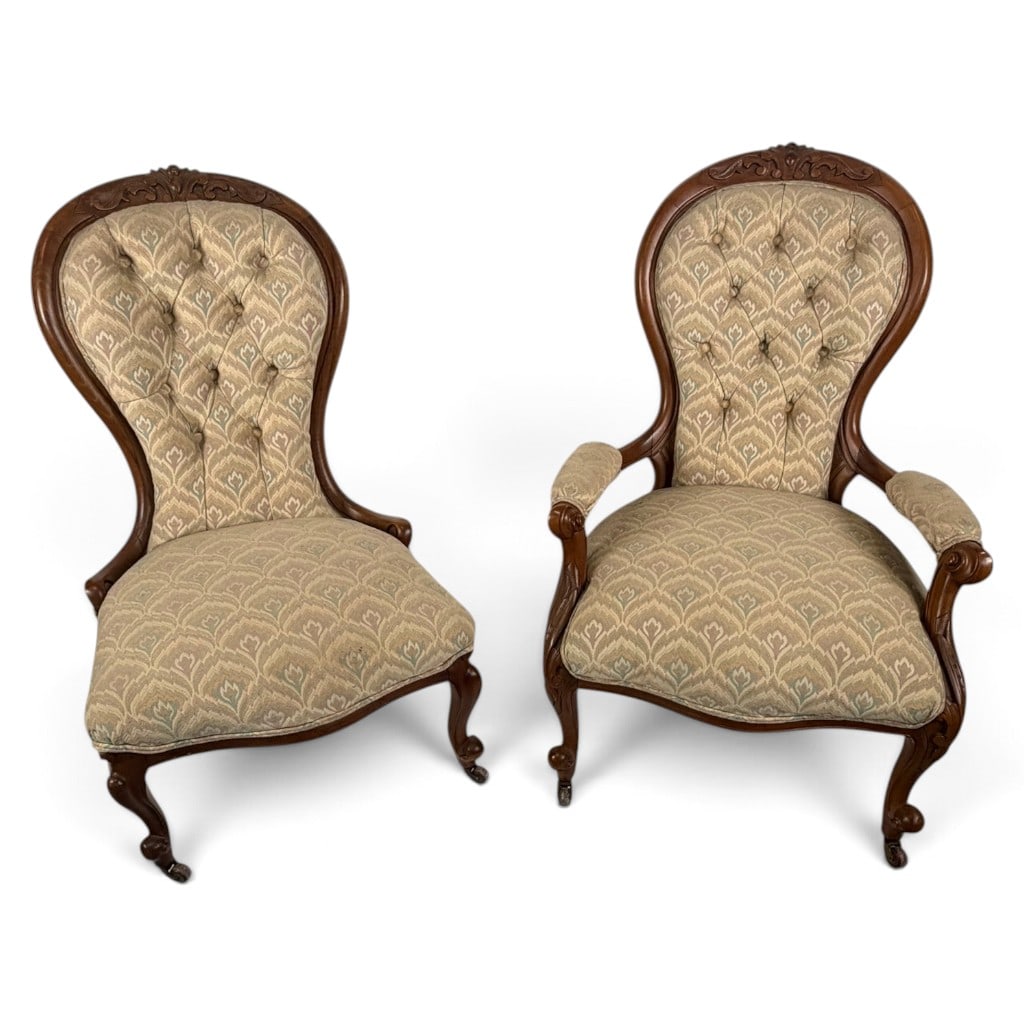 Victorian Walnut His and Hers Parlor Chairs: Origin: American Date: Circa 1860-1880 Period/Style: Victorian, Rococo Revival Materials: Carved walnut, mixed secondary woods, later upholstery, metal fasteners, and casters Form: Coordinated open ar