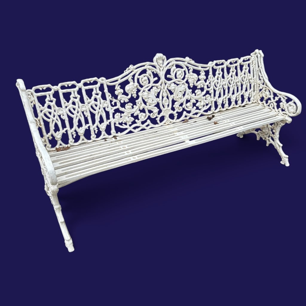 Cast Iron Garden Bench: Origin: Likely American Date: 20th Century Period/Style: Victorian style, Gothic and Rococo Revival influence Materials: Cast iron with white-painted finish Form: Three-seat garden bench Description: