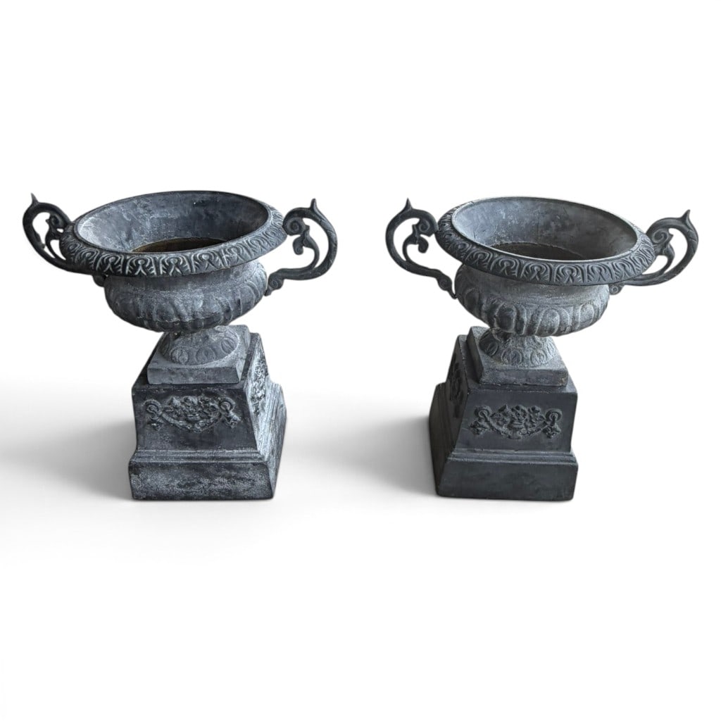 Pair Monumental Cast Iron Garden Urns: Date: 20th century Period/Style: Neoclassical Revival Materials: Cast iron with weathered gray finish Form: Pair of handled garden urns on pedestal bases Description: A substantial pair of cast iron g