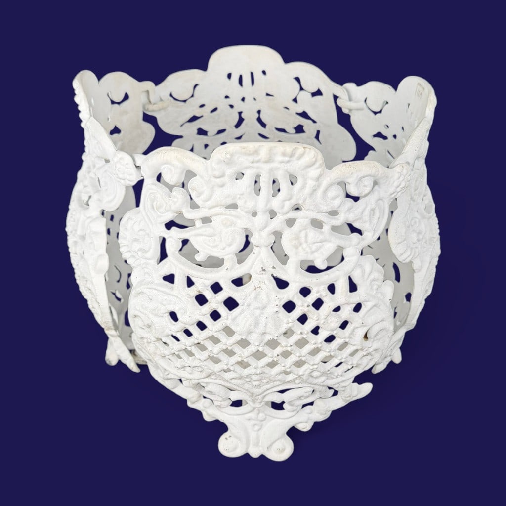 White Openwork Cast Aluminum Garden Planter: Date: 20th century Period/Style: Victorian Revival Materials: Cast aluminum, white-painted finish, and metal fasteners Form: Circular openwork garden planter or cachepot Description: A decorative