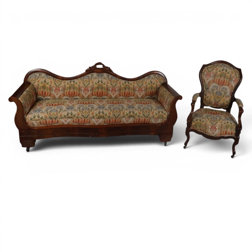 Associated Victorian Sofa and Armchair: Origin: American Date: Sofa circa 1840-1860; armchair circa 1860-1880 Period/Style: Late Classical and Rococo Revival Materials: Mahogany, walnut, mixed secondary woods, damask upholstery, and casters