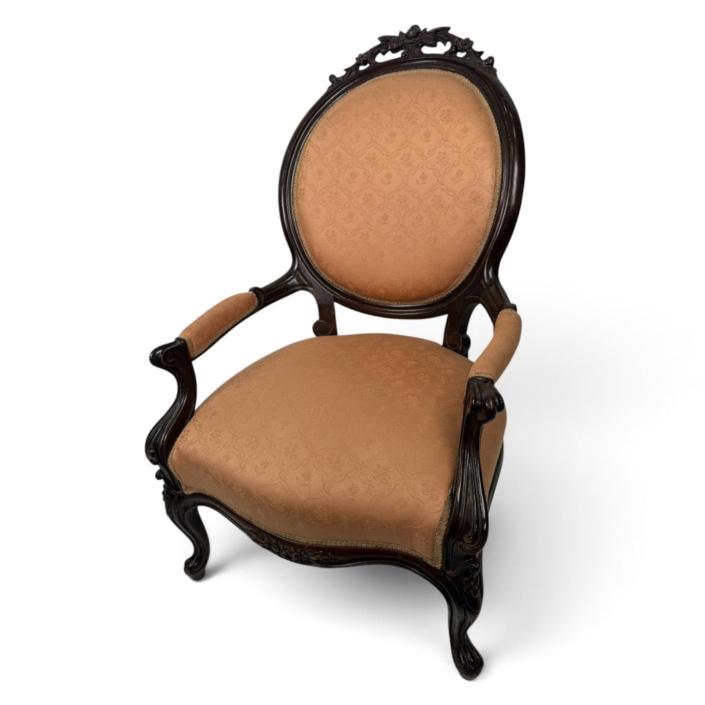 Rococo Revival Oval Back Armchair: Origin: American Date: Circa 1860-1875 Period/Style: Victorian, Rococo Revival Materials: Walnut, mixed secondary woods, later woven upholstery, and metal fasteners Form: Oval-back parlor armchair