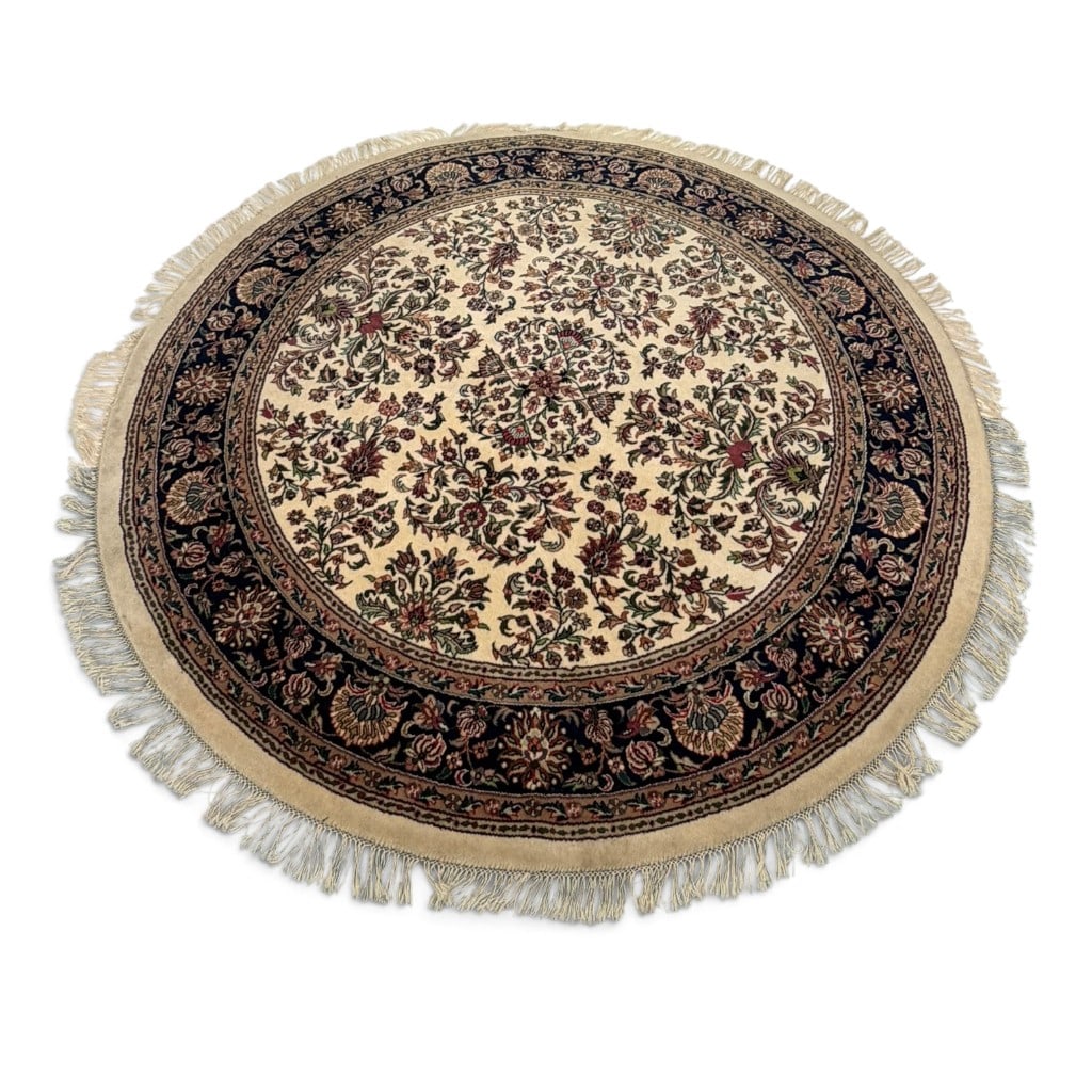 Hand Knotted Floral Round Rug: Origin: Probably South or West Asia Date: Late 20th century Period/Style: Persian-style floral design Materials: Wool pile on a cotton foundation Form: Round area rug Description: A decorative round