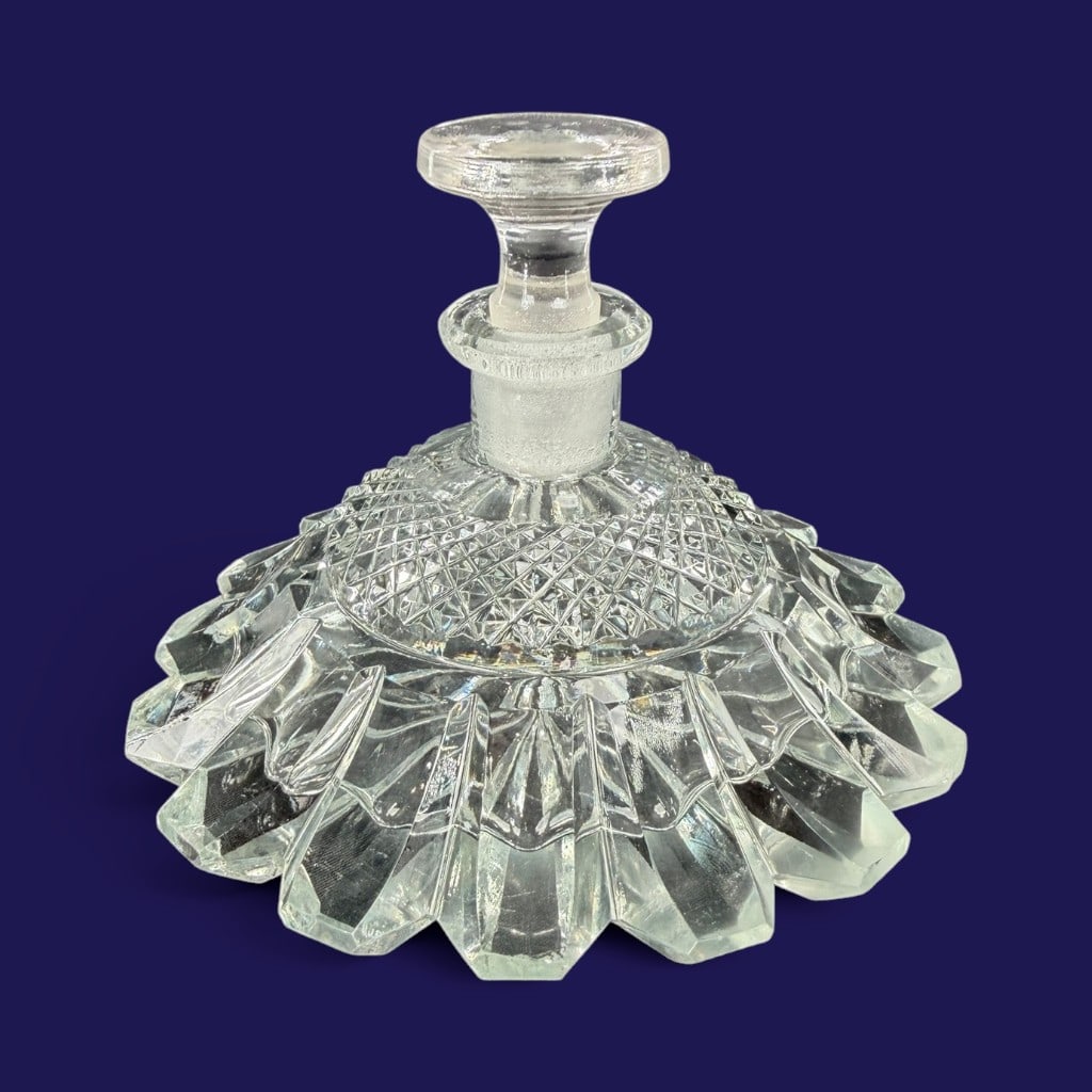 Cut Glass Pancake Perfume Bottle: Origin: Probably American Date: Circa 1900-1920 Period/Style: Late Victorian or early 20th century Materials: Clear lead glass Form: Pancake-form perfume or cologne bottle Description: A clear
