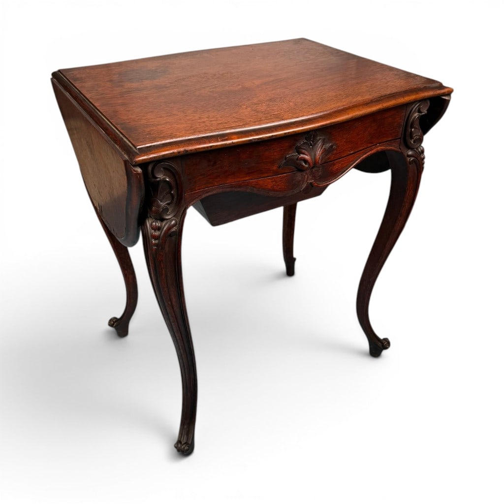 Rococo Revival Rosewood Work Table: Origin: American Date: Circa 1850-1870 Period/Style: Victorian, Rococo Revival Materials: Rosewood and rosewood veneer, bird's-eye maple, mixed secondary woods, and brass hardware Form: Sewing or work