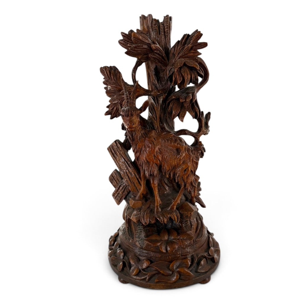 Swiss Black Forest Chamois Figural Candlestick: Origin: Probably Brienz, Switzerland Date: Circa 1890-1910 Period/Style: Black Forest, Alpine naturalism Materials: Carved and stained wood Form: Single-light figural candlestick Description: A