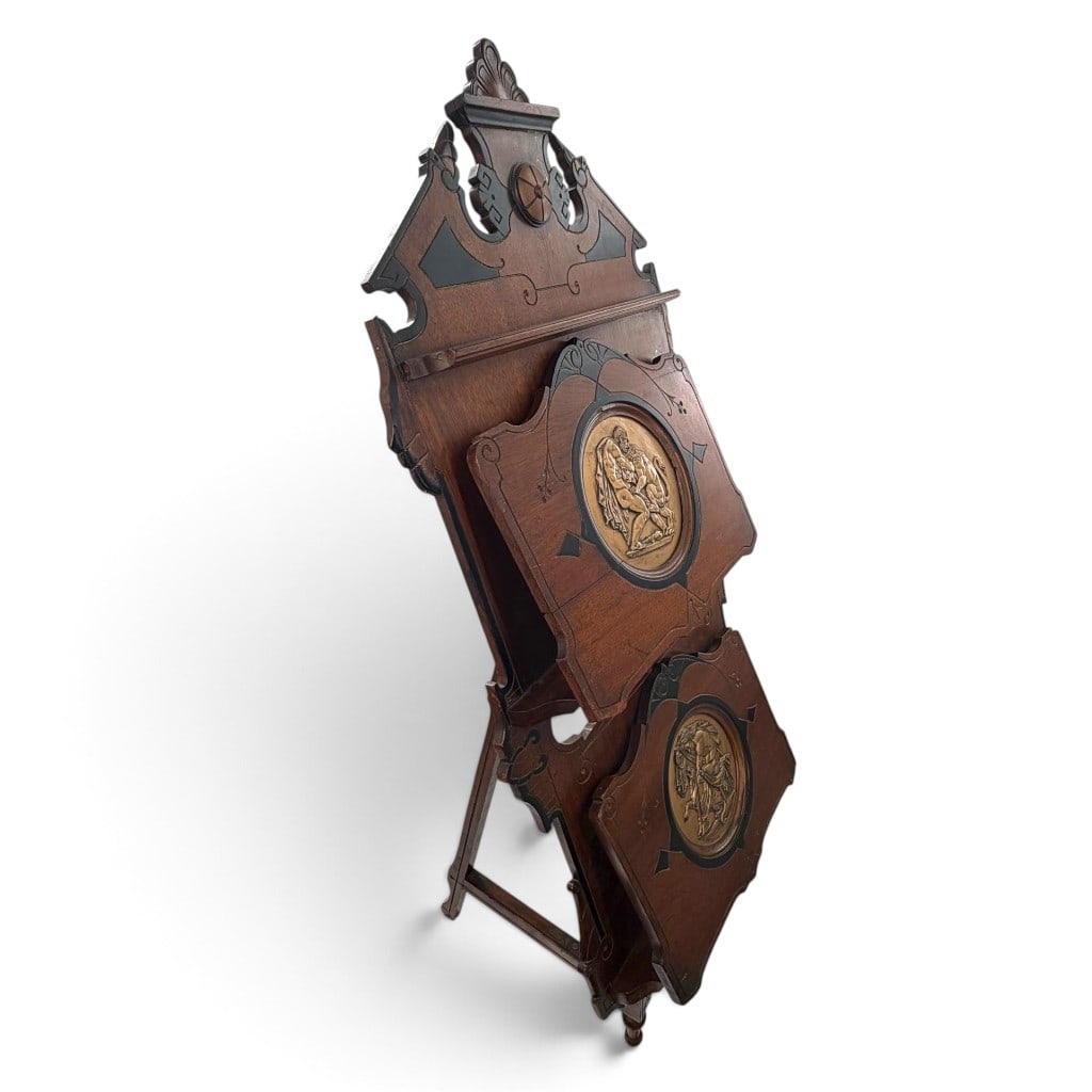 American Aesthetic Walnut Music Stand: Origin: American Date: Circa 1880 Period/Style: Aesthetic Movement, Eastlake Materials: Walnut, ebonized wood, gilt metal, and metal hardware Form: Folding sheet-music portfolio stand Description: An