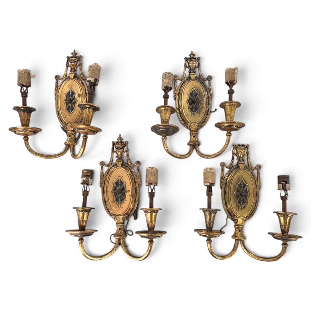Four Lion Electric Gilt-Brass Sconces: Origin: American Date: Circa 1920-1930 Period/Style: Neoclassical Revival with Egyptian Revival details Maker: Lion Electric Manufacturing Company Materials: Gilt and parcel-painted cast brass, steel