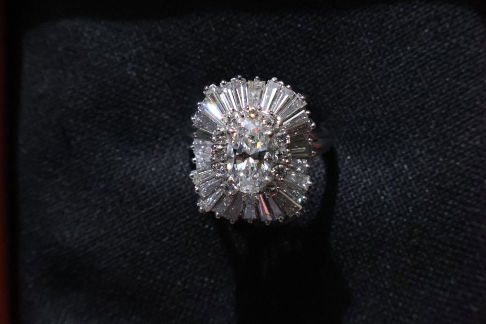 GIA Platinum 3.94 CTW Diamond Ring: Date: Late 20th to early 21st century Materials: Platinum and diamonds Form: Ballerina-style ring Description: A platinum ballerina-style ring centered by a GIA-graded 0.94 carat oval brilliant
